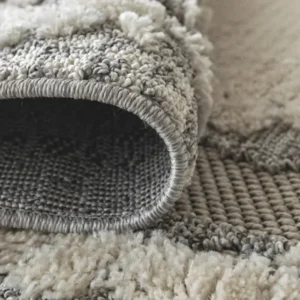 Beige rust abstract rug in bedroom
