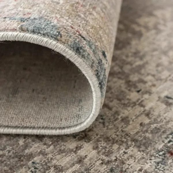 Beige rust abstract rug in bedroom