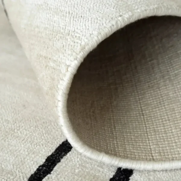 Pearl black border rug in bedroom