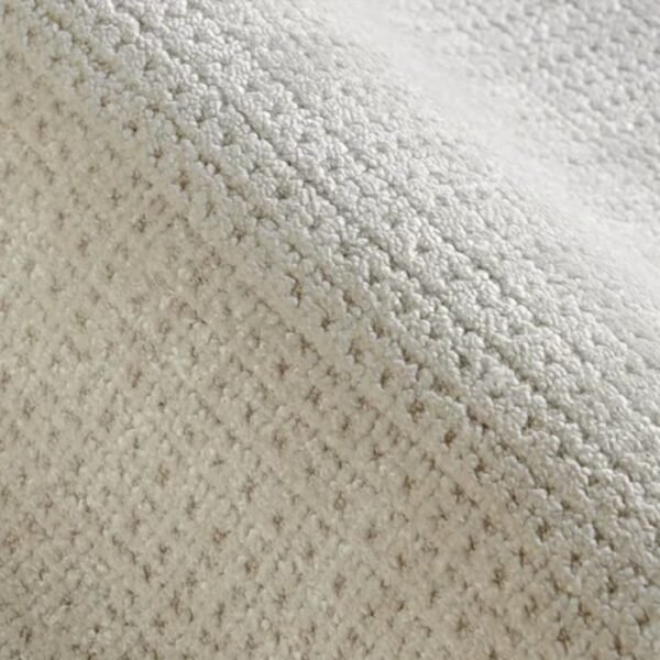 Rolled up textured grid pattern rug