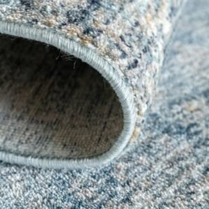 Folded distressed rug with blue tint