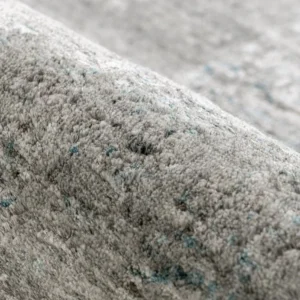 Folded grey abstract rug on floor