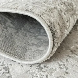 Folded abstract rug showing wear pattern