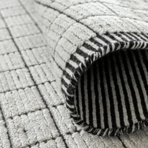 Folded black and white grid rug