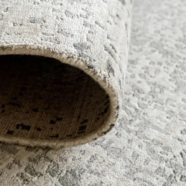 Folded greyish abstract rustic rug