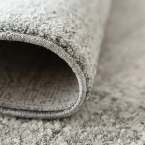 Folded rug showing faded pattern texture