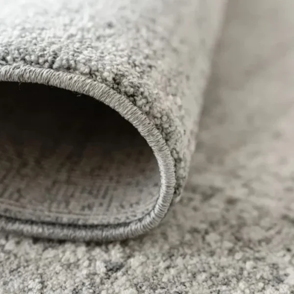 Folded rug showing faded pattern texture