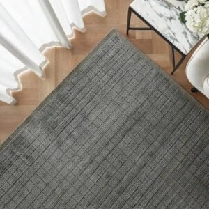 Soft rug featuring a geometric grid layout