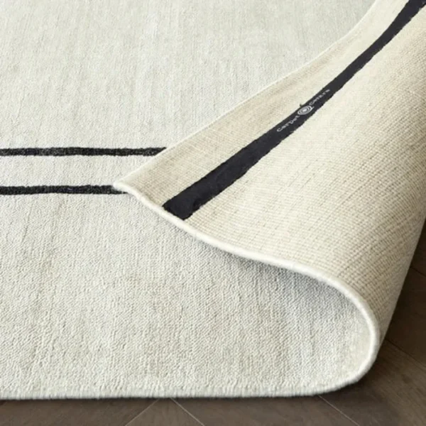 Pearl rug with black border in living room