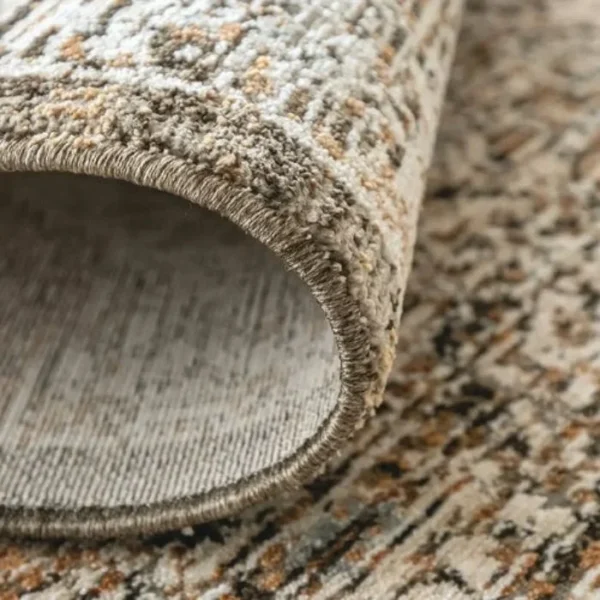 Repeating medallion design on faded rug
