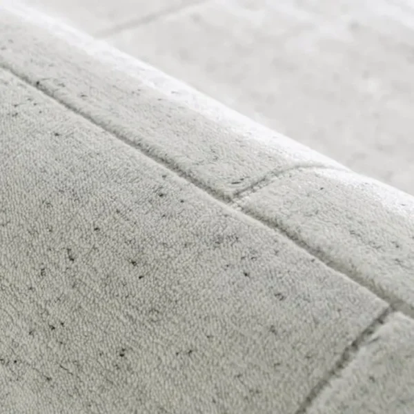 Grey textured rug with linear tufting