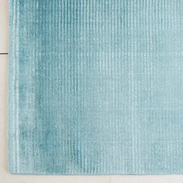 Turquoise striped area rug