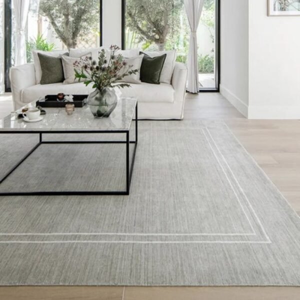 Grey rug featuring white edge border
