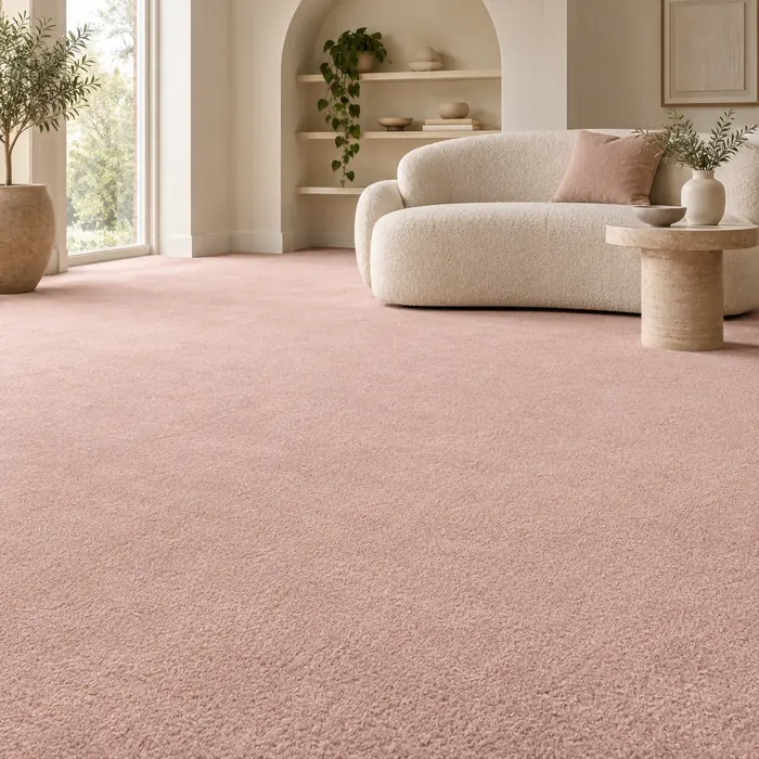Blush pink carpet in a calm sitting room with an arched alcove and ivory loveseat.