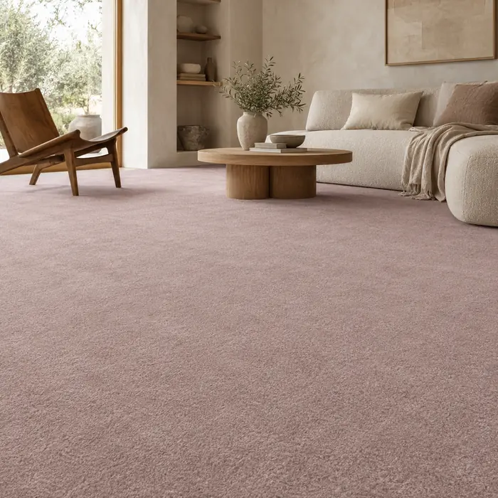 Muted dusty pink carpet in a Japandi lounge with a low sofa and wooden accent chair.